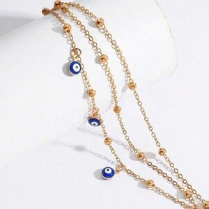 Gold Evil Eye Bracelet with Blue Charms